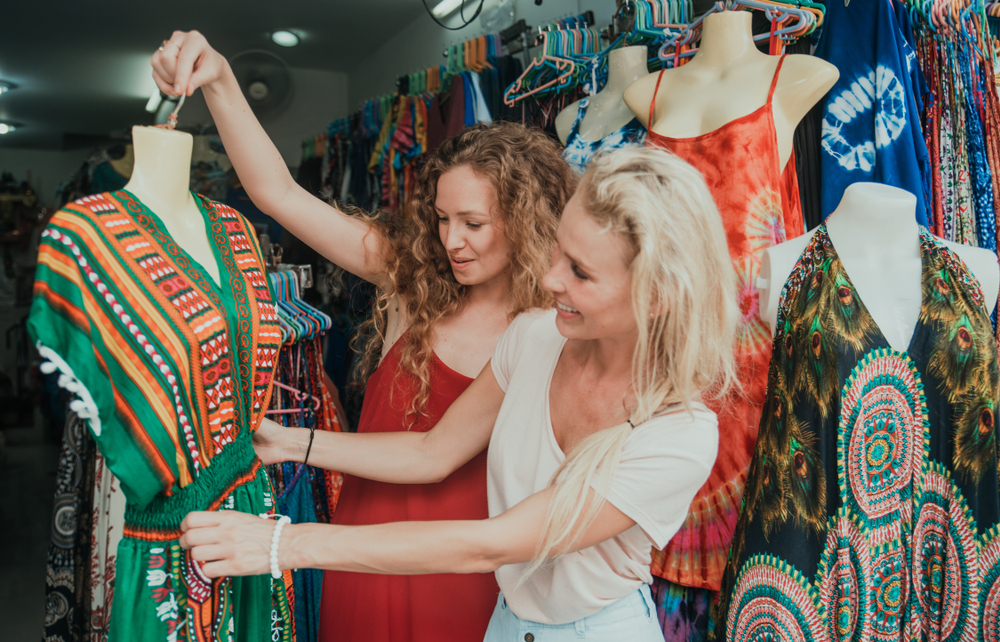A traveller shopping for a souvenir from Thailand inside a small Bangkok gift shop

